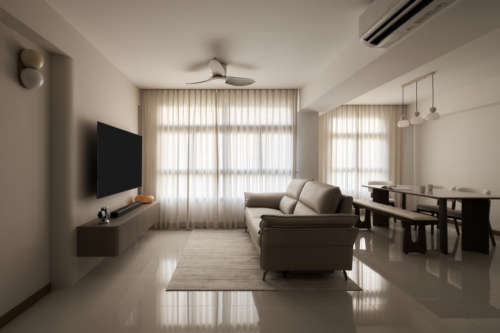 HDB interior design with TV area, sofa, and dining space for comfortable modern family living