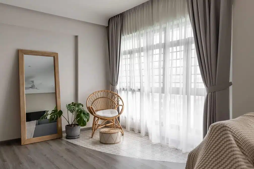 HDB interior with natural materials, blind curtains, and chair creating a warm, modern, and functional living space