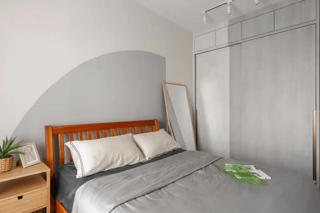 Scandinavian style bedroom with sofa bed, textured wall design, and cozy minimalist interior ambiance