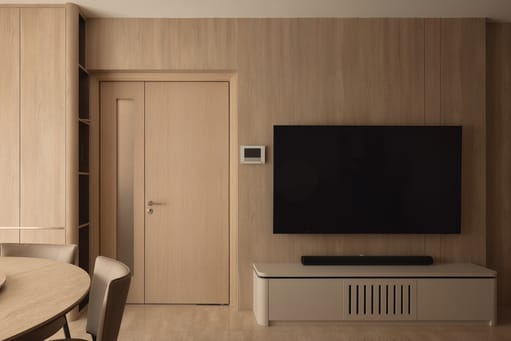 12 Keppel Bay condo living room with wall-mounted TV, sleek TV stand, and luxe modern interior design.