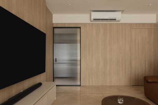 12 Keppel Bay condo living room with TV, split-type aircon, and stylish accent wall in a luxe modern interior.