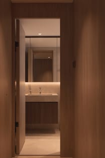 12 Keppel Bay condo hallway leading to the bathroom, featuring luxe interior design, elegant finishes, and modern decor.